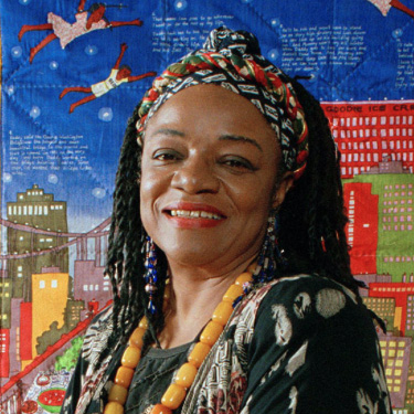women who changed art forever: Faith Ringgold in front of Tar Beach #2 (1990) quilt, 1993. Photograph by Kathy Willens. Blackpast. Detail.
