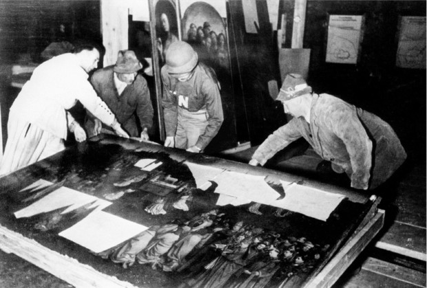 Monuments Men: George Stout, third from left with an "N" on his shirt, moving the central panel of the Ghent Altarpiece in Altaussee, Austria in July of 1945.