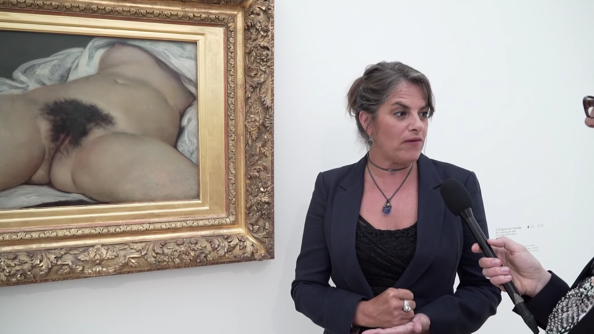 Tracey Emin in front of Gustave Coubert's The Origin of The Worlf