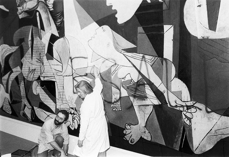 protest art: Curators clean graffiti from Guernica at MoMA New York.