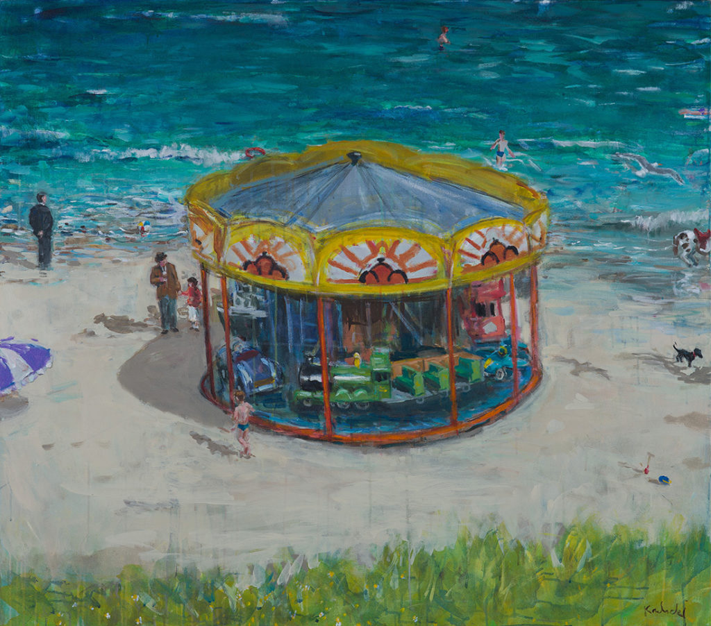 Seaside carousel. Fairground ride on the beach at summertime. 