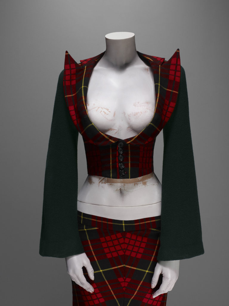 Alexander McQueen, Highland Rape collection, F/W 1995-6, Suit, jacket of McQueen wool tartan with green wool felt sleeves; skirt of McQueen wool tartan (the ensemble was not worn together on the runway), Source: The Metropolitan Museum of Art, New York, USA.