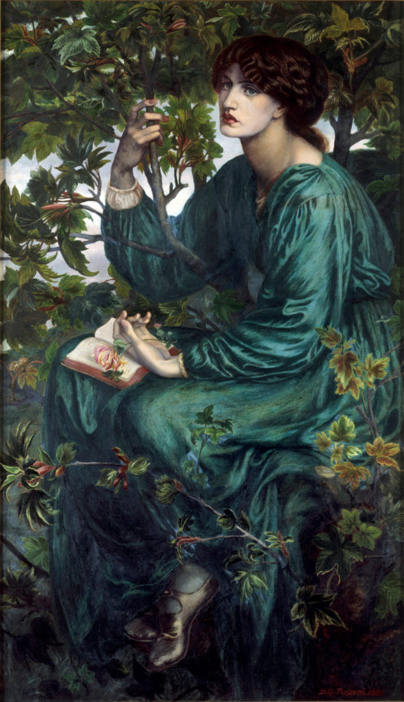 Jane Morris: Jane Morris posing in a seated position on the branch of a sycamore tree with a small stem of honeysuckle is in her hand