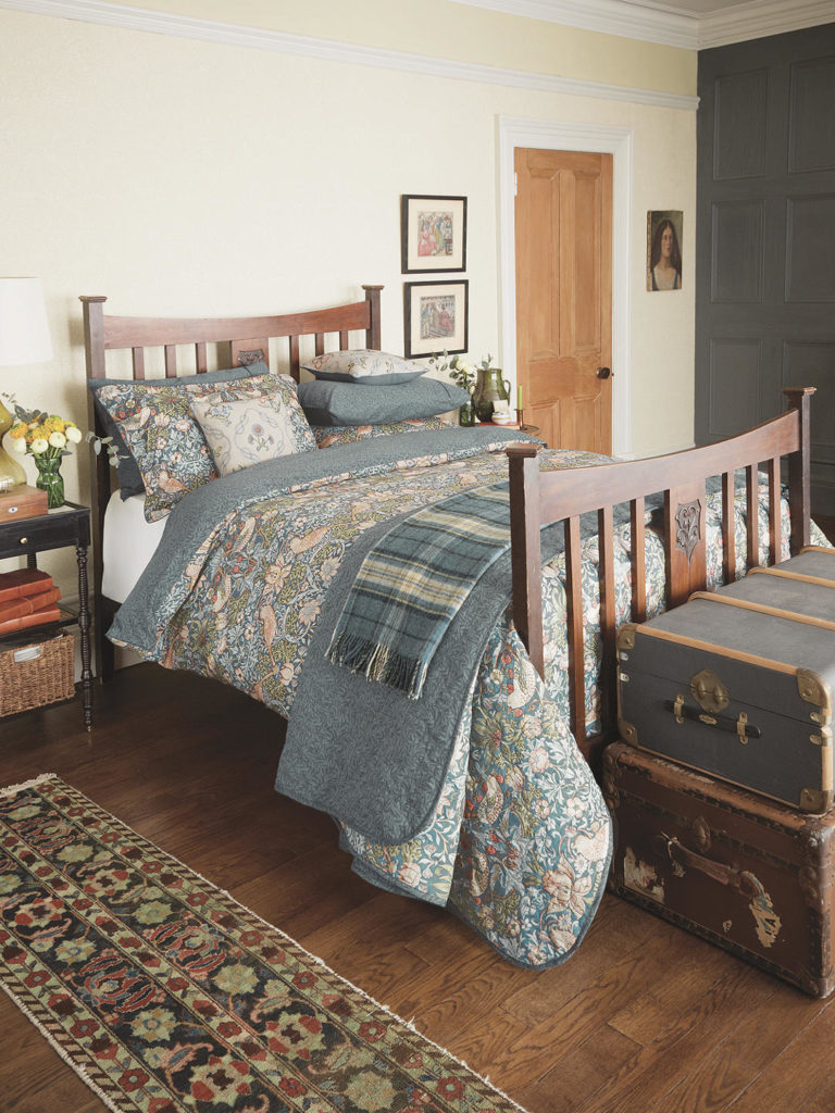 a rustic bedroom with a floral duvet; Prints of William Morris