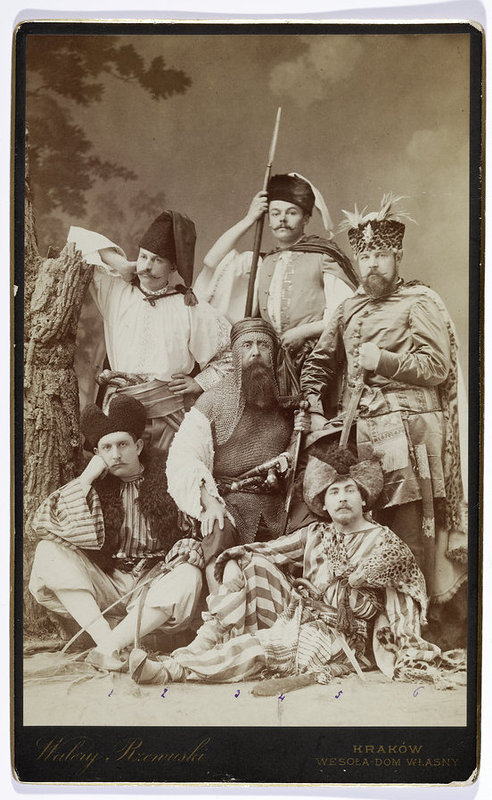 A group of people in historical costumes in a studio – a tableau vivant based on Henryk Sienkiewicz’s With Fire and Sword: