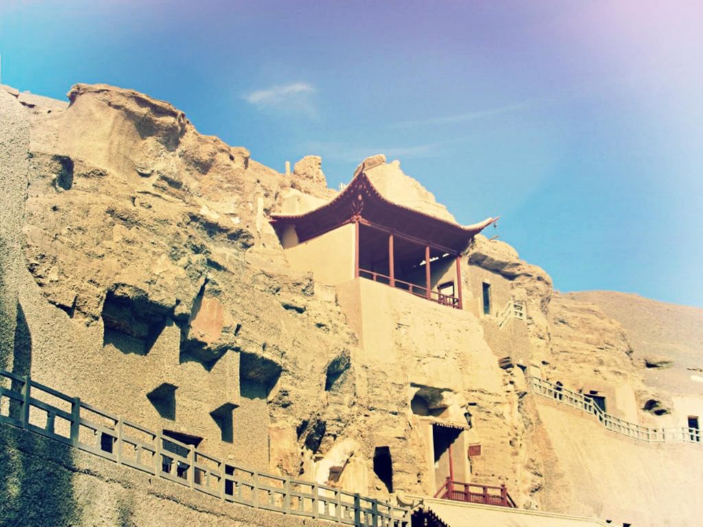 temples cut in the mountain with the staircase in the foreground