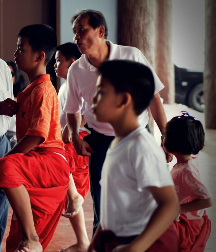 The Khon (Thai masked dance drama) training with children practicing movements and the instructor looking at the side