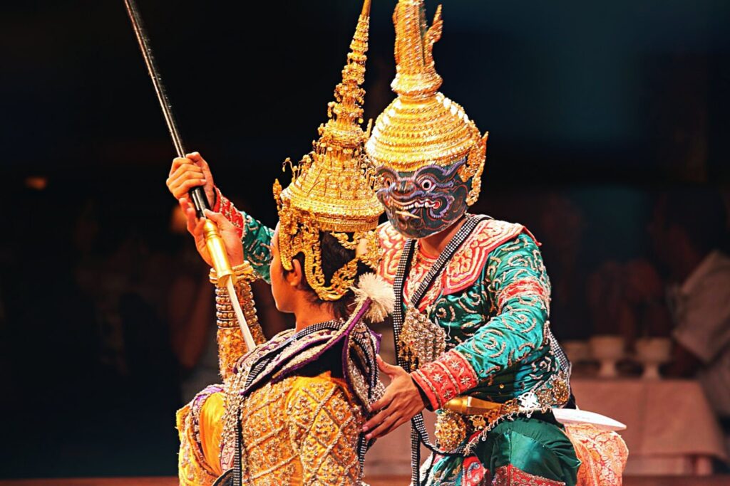 The Khon (Thai masked dance drama) performance with the male dancer in the traditional costume and mask and the female dancer in the traditional costume and headdress