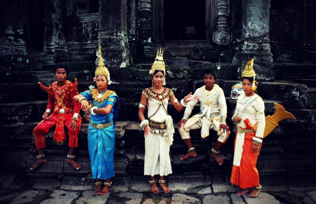 The group of five dancers in the traditional Khmer costumes at the footsteps of the Bayon temple in Cambodia