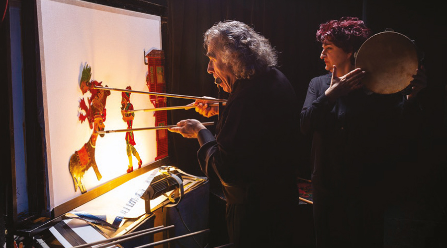 Karagözcu and assistant performing Turkish shadow puppet theater.