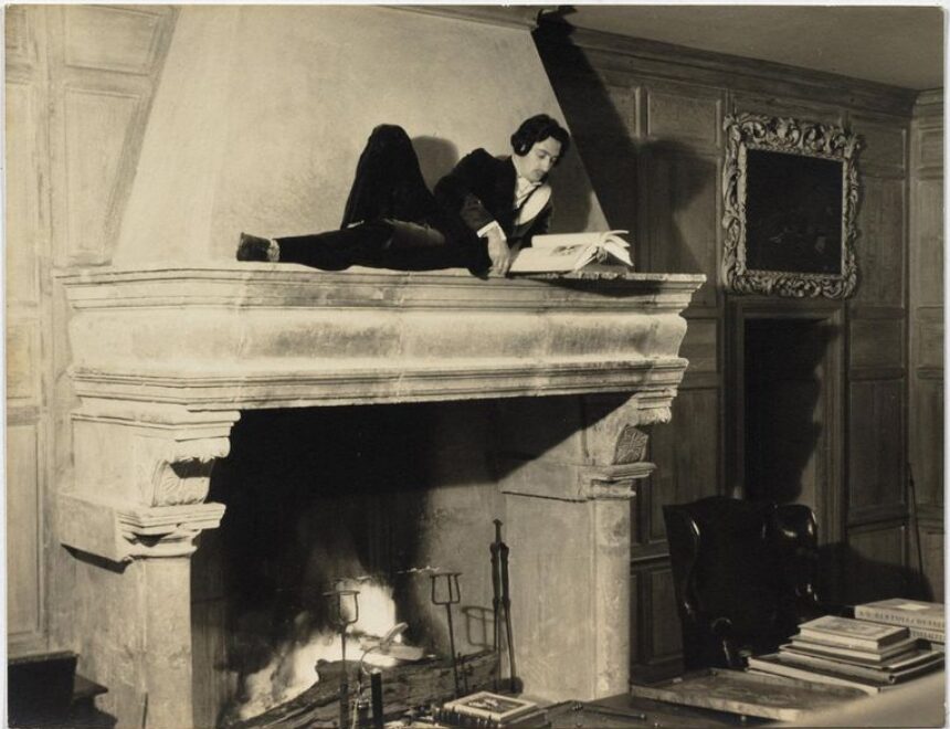 The Friendship of Salvador Dali and Coco Chanel: The Friendship of Salvador Dali and Coco Chanel. Salvador Dali reading on the mantlepiece at the Villa La Pausa, c.1938, Artnet. 