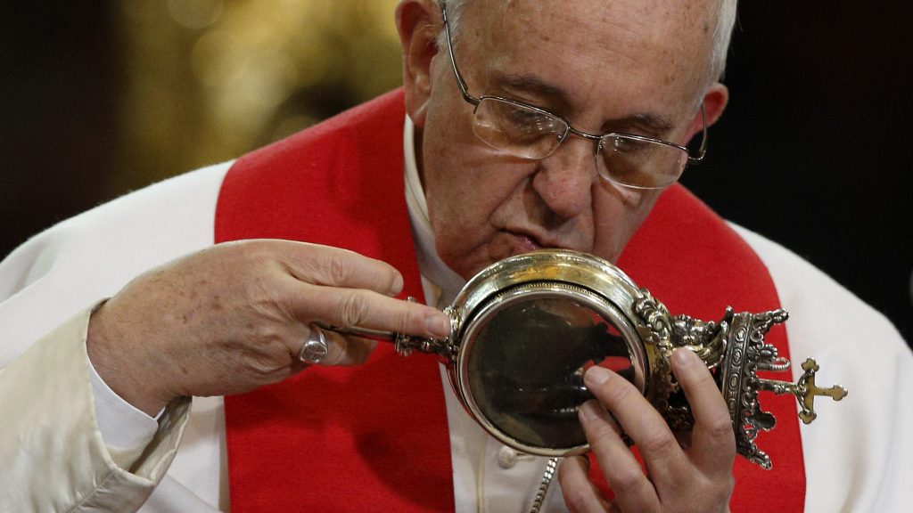 Top 10 Christian Weird Relics: Pope Francis kisses a reliquary containing what is believed to be the blood of St. Januarius during a meeting with religious at the cathedral in Naples, Italy, in 2015