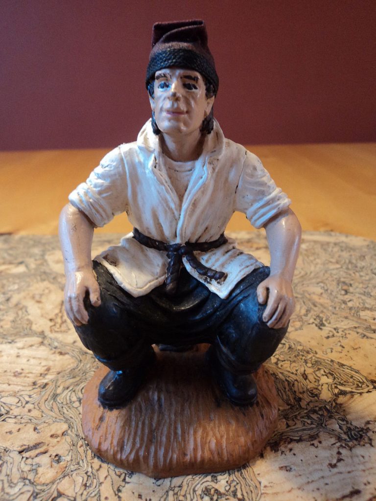 Traditional caganer from the Fira de Santa Llucia, Barcelona, 2012. Photo by Roeland P., Wikimedia Commons.
