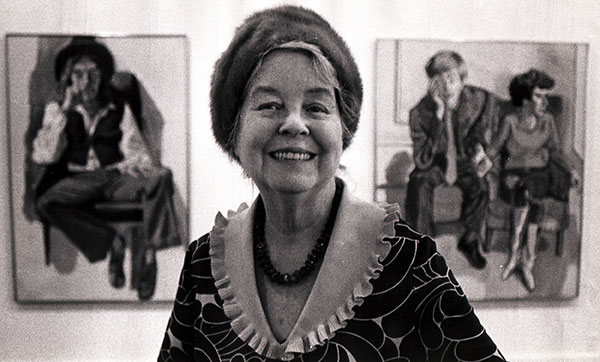 Alice Neel pictured with her paintings in the background, 1970
