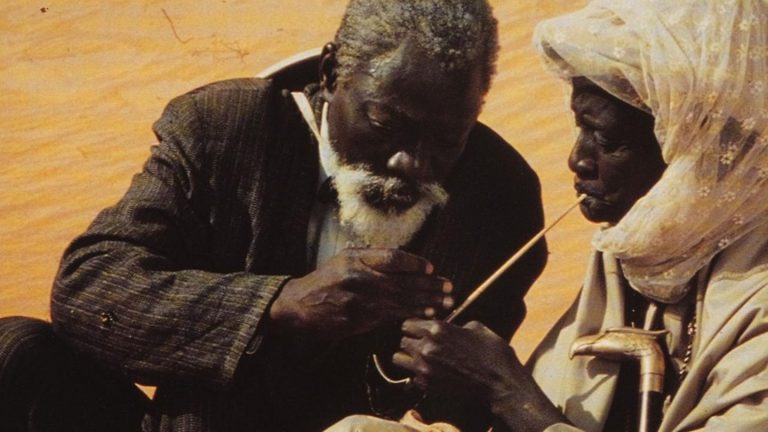 Djibril Diop Mambéty: Movie still from Hyènes, directed by Djibril Diop Mambéty, 1992. Independance Set Creation.
