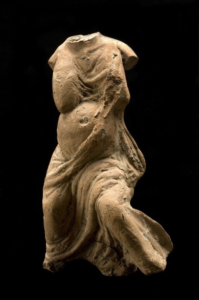 pregnancy in art: Damaged roman votive female pregnant figurine, Wellcome Collection, London, UK.
