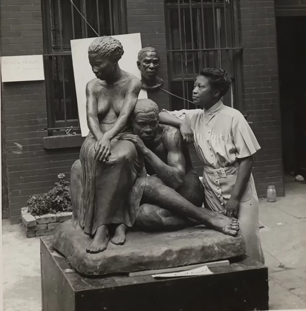 Augusta Savage photographed with her 1938 sculpture Realization.