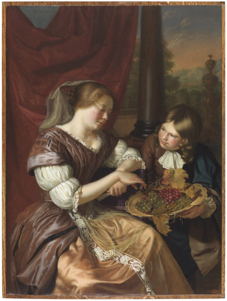 new year traditions Boy offering grapes to a woman