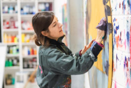 Photograph of Orlanda Broom painting in her studio.