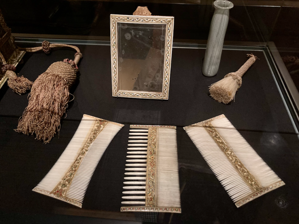 titian vision of women: Toilet Box containing ivory double-combs, a mirror, and a brush, glass bottle (Burano), mid-16th century, Venice, Kunsthistorisches Museum, Kunstkammer, Vienna, Austria.