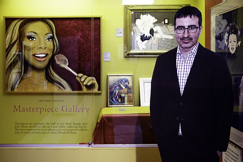 A cutout of John Oliver in front of the paintings in Last Week Tonight's Masterpiece Gallery at the Judy Garland Museum.