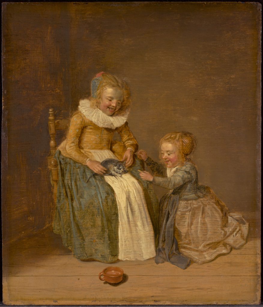 Dutch interior with two girls - one kneels on the floor next to the girl in the chair with a cat in her lap.