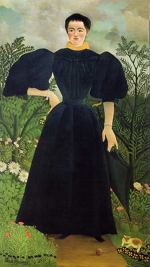 Full length portrait of a woman with her hand on her hip, standing in a landscape. A cat plays at her feet.