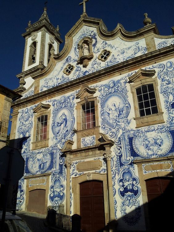Portuguese azulejos cover the exterior of the Santa Maria Church in Covilhã, Portugal. Pinterest.