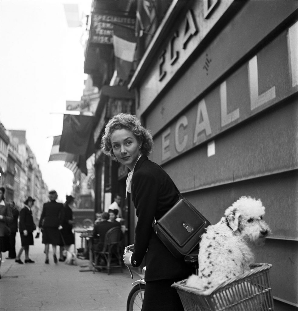Fashion Photographers, Lee Miller, Leaving the Pierre et Rene hairdresser, poodle travels in a bicycle basket, Paris, 1944