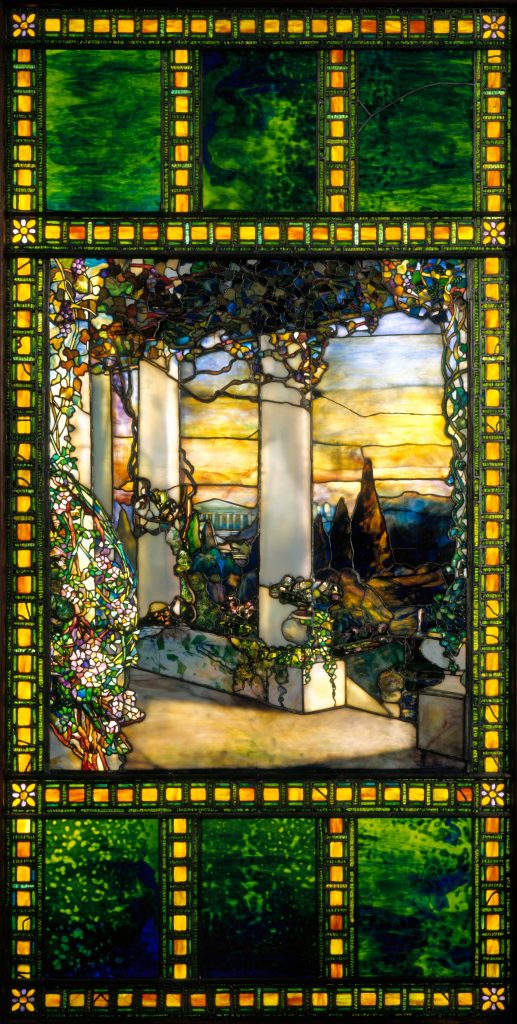 Tiffany's window pane depicting columns on a patio overlooking a landscape.