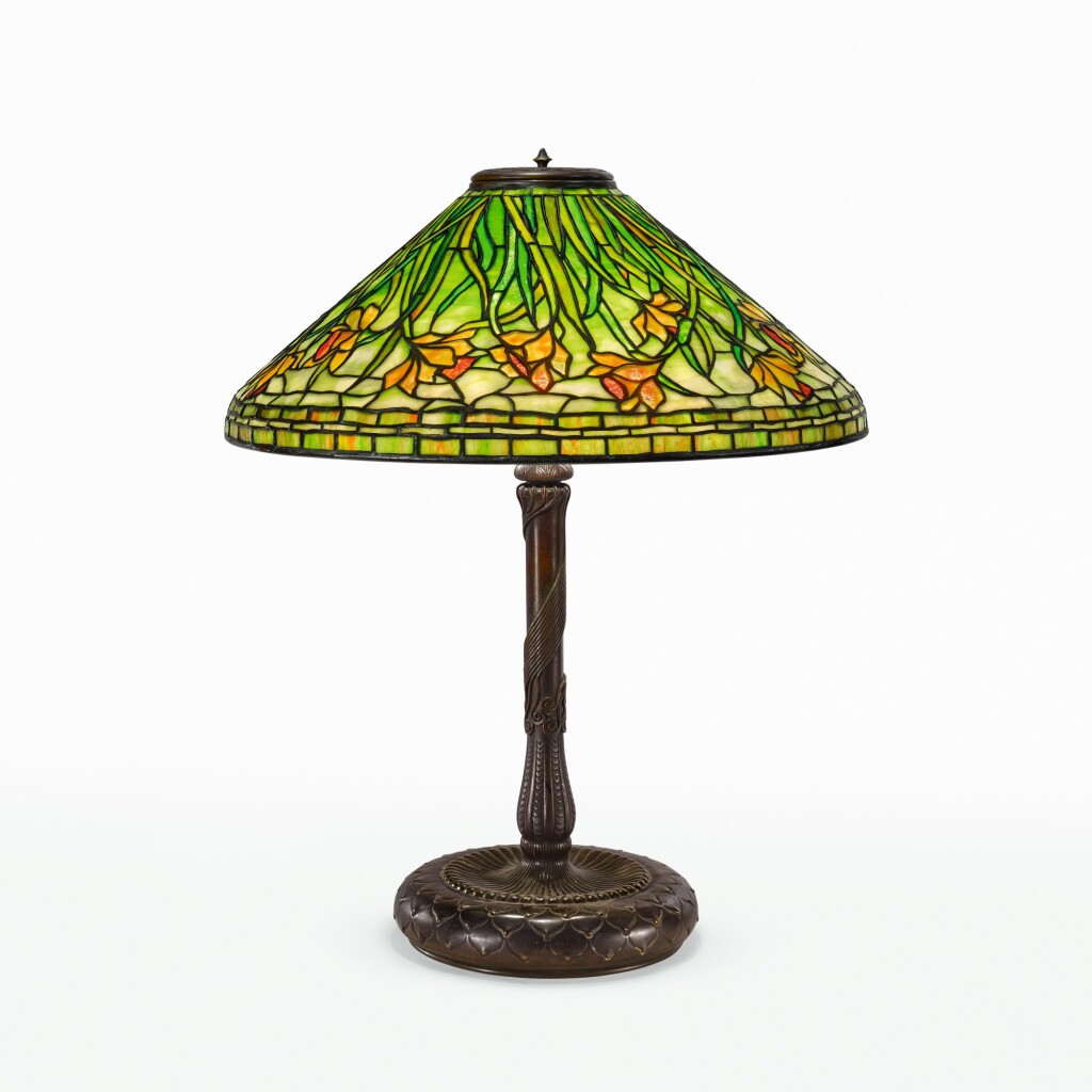 Tiffany's lamp with green and orange floral pattern in a conical shape.