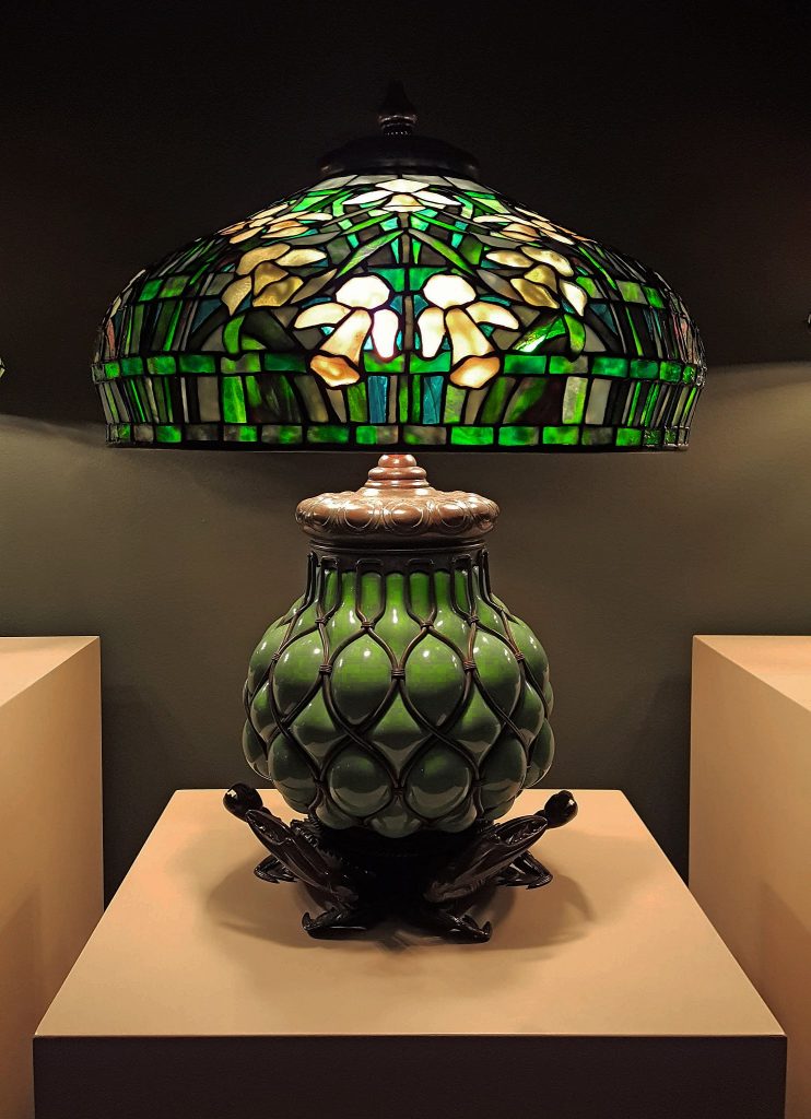 Green Tiffany's lamp with an ornate green base.
