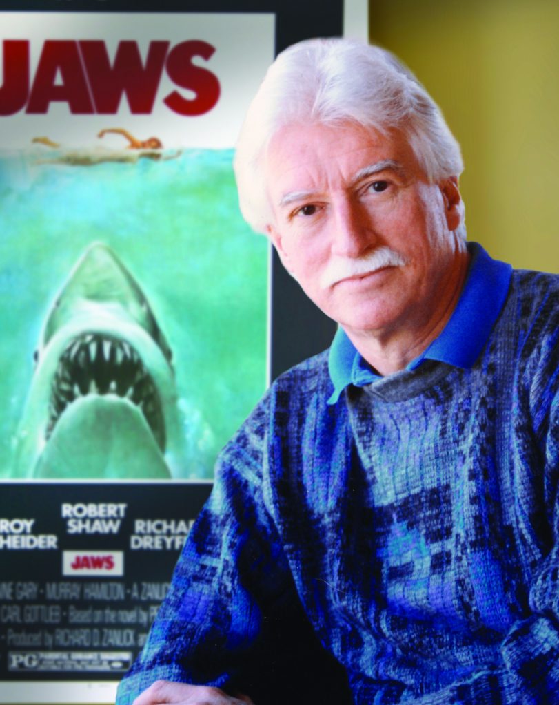 jaws painting missing: Roger Kastel in front of the movie poster for Jaws directed by Steven Spielberg, 1975. Courtesy of Illustration Magazine.
