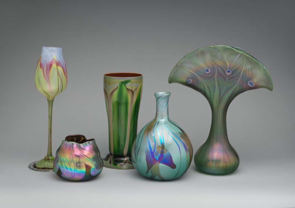 Favrile glassware with wine class and four vases.