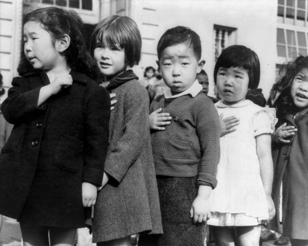 female photographers: Dorothea Lange, Children at the Weill public school in San Francisco pledge allegiance to the American flag, 1942. Wikimedia Commons (public domain).
