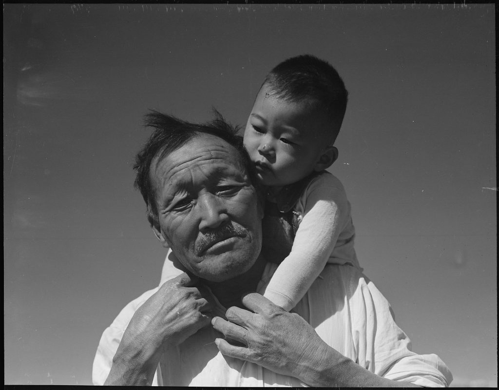 women photographers, Dorothea Lange, Manzanar Relocation Center, Manzanar, California. Grandfather and grandson of Japanese ancestry at, 1942.