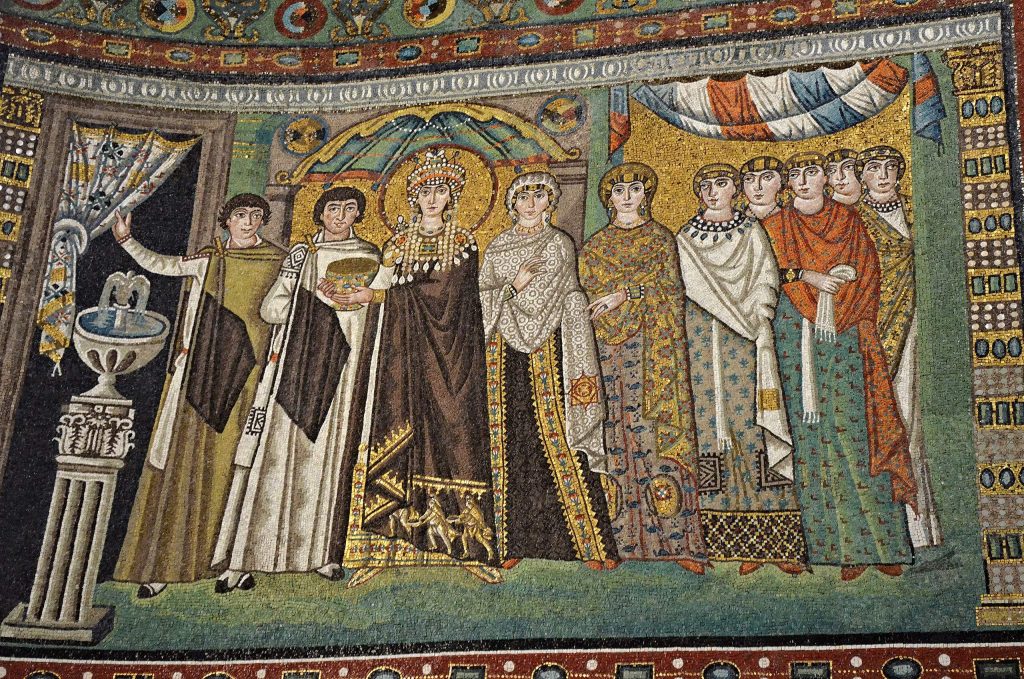 San Vitale mosaics: Empress Theodora and Her Retinue mosaic, San Vitale, Ravenna, circa 526-547 CE, Italy. Photo by Following Hadrian via Wikimedia Commons (CC BY-SA 2.0).
