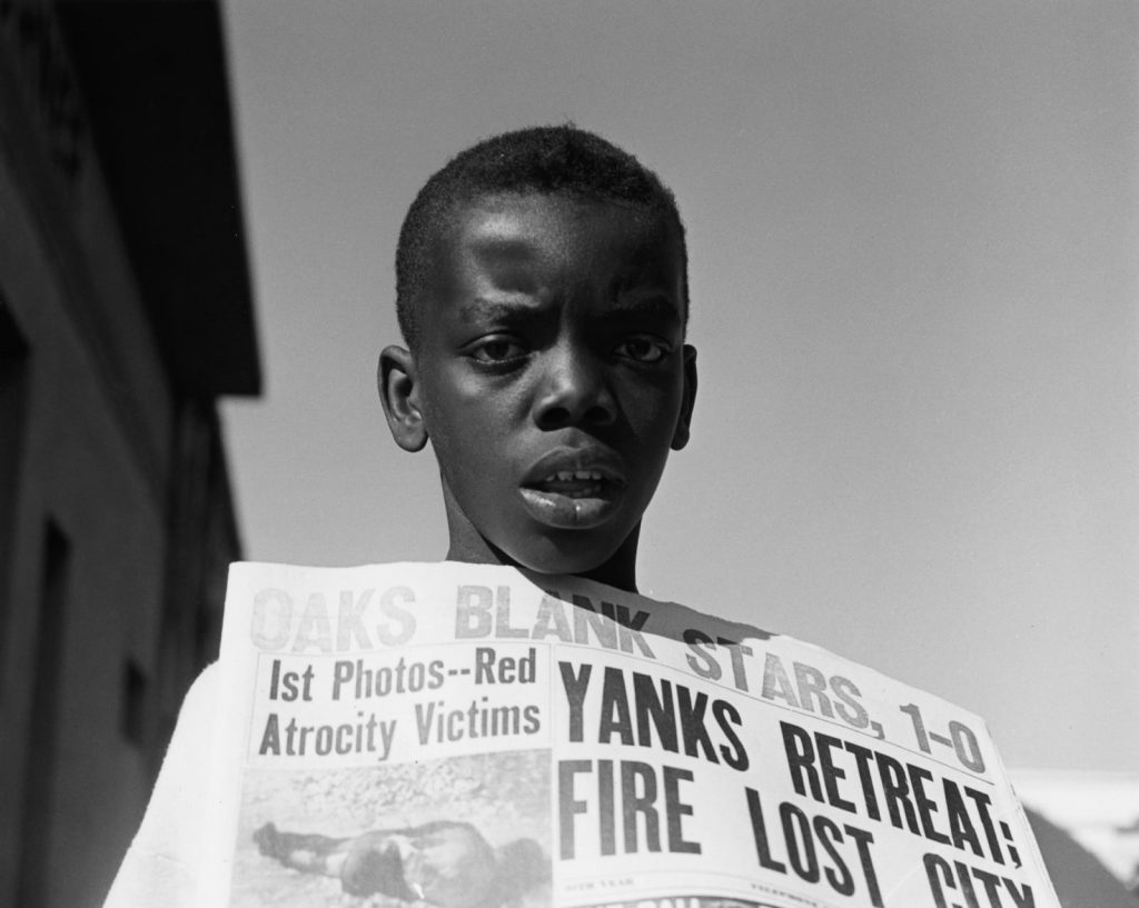 female photographers: Imogen Cunningham, Boy Selling Newspapers, c. 1950. Artist’s website.
