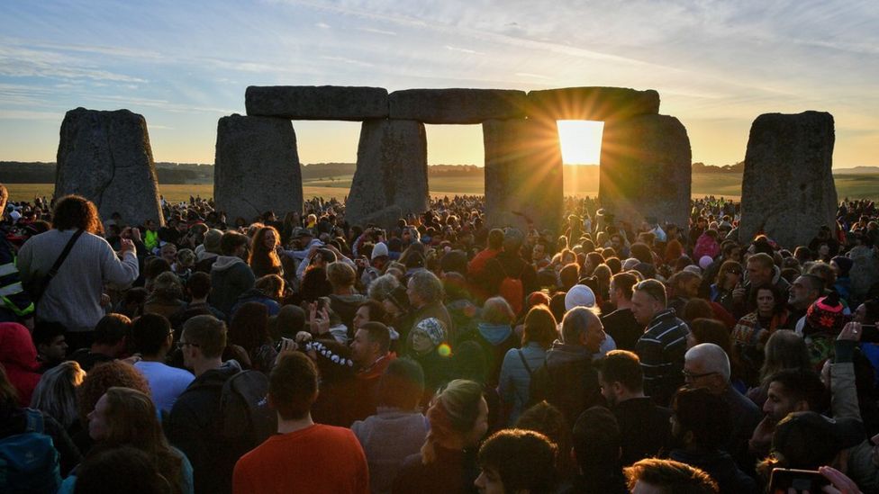 Stonehenge: People waiting for the sunrise on June 21st, or summer solstice. BBC.
