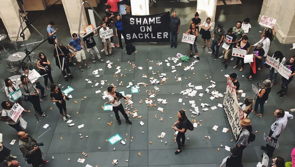 Nan Goldin: Nan Goldin, Shame on Sackler demonstration, 2019, Solomon R. Guggenheim Museum, New York, NY, USA. PAIN.

