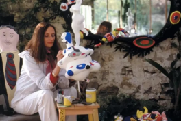 Niki de Saint Phalle surrounded by her sculptures painting Le Monde, c. 1981. Photograph by Laurent Codominas © 2010 Niki Charitable Art Foundation. Courtesy of Opera Gallery. Detail.