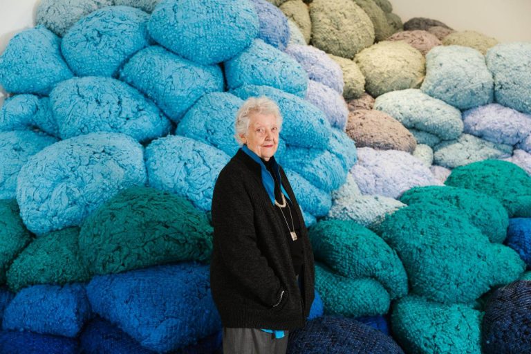 Sheila Hicks: Sheila Hicks at her exhibition at the Hepworth Wakefield, Wakefield, UK. Photograph by Joanne Crawford. 
