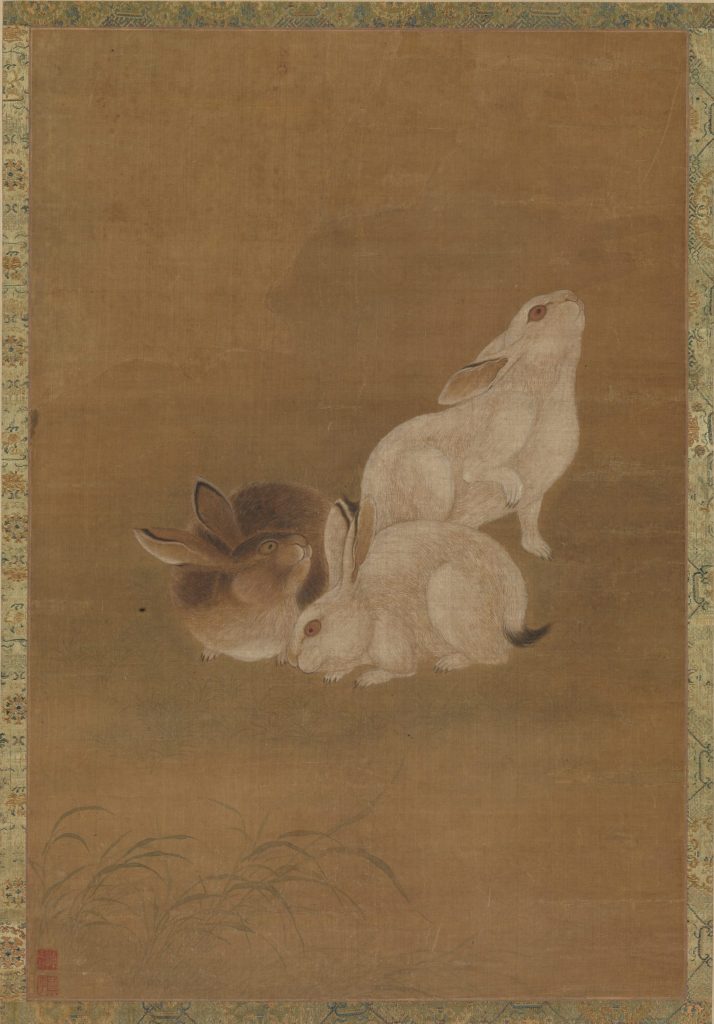 Silk scroll depicting three rabbits. One is brown, two are white.