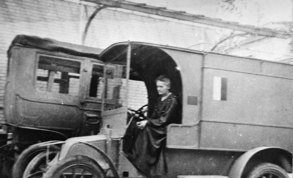 Marie Curie portraits: Marie Curie driving a “Little Curie,” 1917, Musée Curie, Paris, France.

