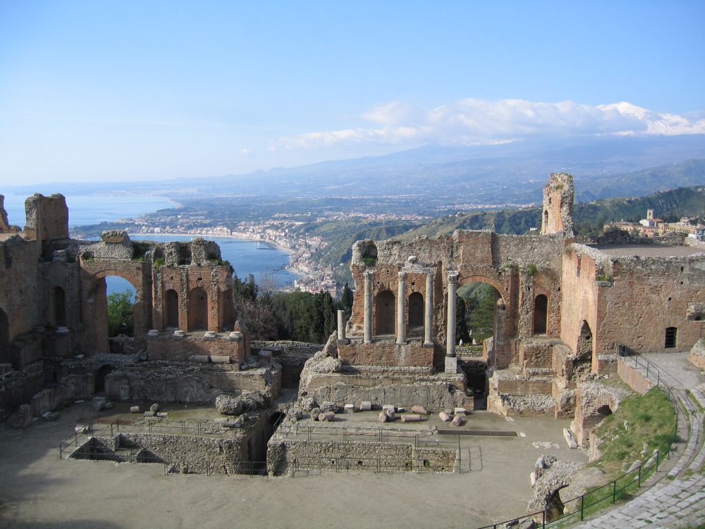 The White Lotus: The ancient theatre of Taormina, Italy. Wikimedia Commons (public domain).
