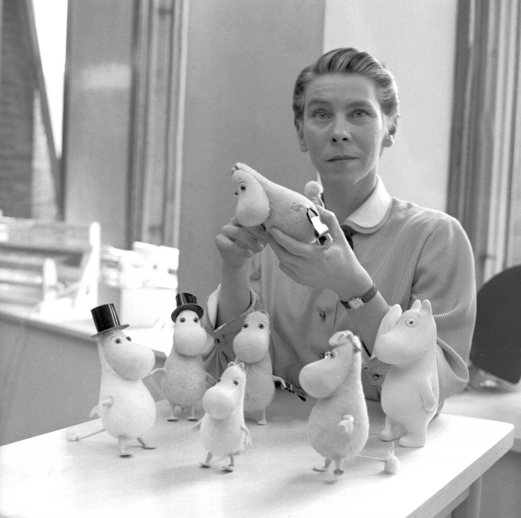 Tove Jansson Moomins:  Reino Loppinen, Tove Jansson with Moomin figurines, 1956. Wikimedia Commons (public domain).
