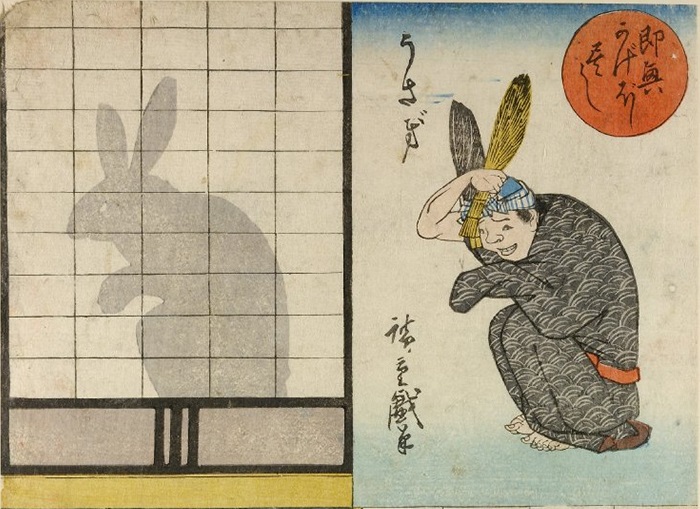 Omocha-e chart. On the left side is depicted translucent shoji screen with a rabbit shadow, on the right side of chart is presented man in disguise posing as a rabbit.