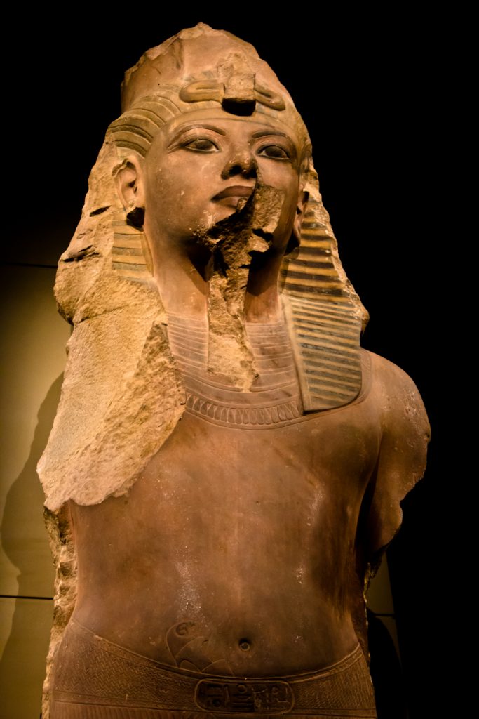 Tutankhamun: Colossal Statue of Tutankhamun, 1355-1315 BCE, Funerary Temple of Ay and Horembheb, Luxor, Egypt. Photograph by Dmitry Denisenkov via Wikimedia Commons (CC-BY-SA-2.0).
