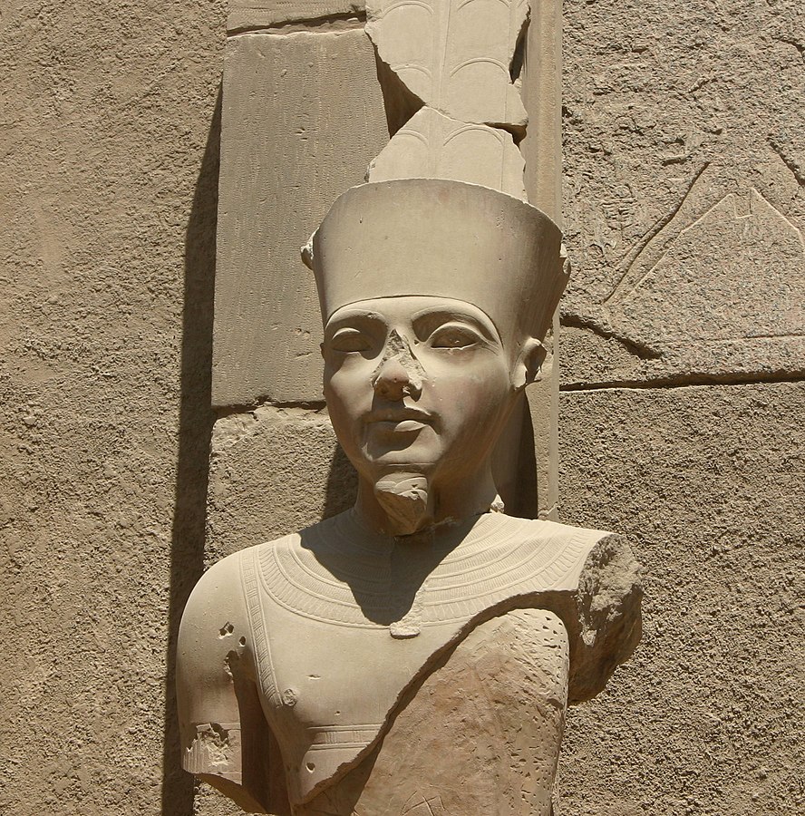 Tutankhamun: Statue of Amun with features of Tutankhamun, Karnak Temple of Amun-Ra, Luxor, Egypt. Photograph by Markh via Wikimedia Commons.
