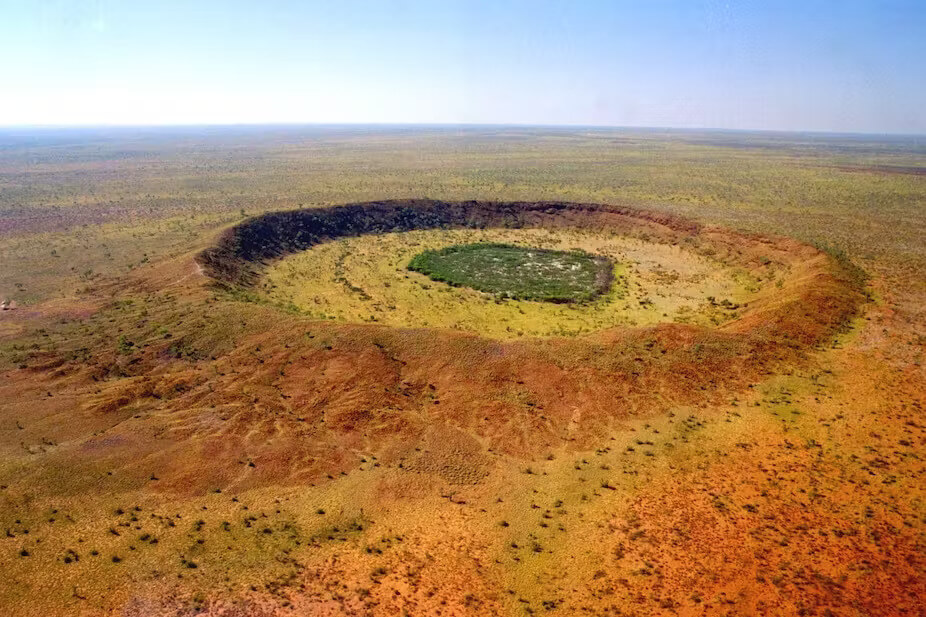 Indigenous Australian: Wolfe Creek Crater, Great Sandy Desert, WA, Australia. Photo by Dainis Dravins – Lund Observatory, Sweden, via The Conversation.
